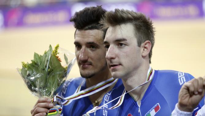 Italy's Liam Bertazzo and teammate Elia Viviani pose with their silver medals for the Men's Madison final at the UCI Track Cycling World Cup in Saint-Quentin-en-Yvelines, near Paris